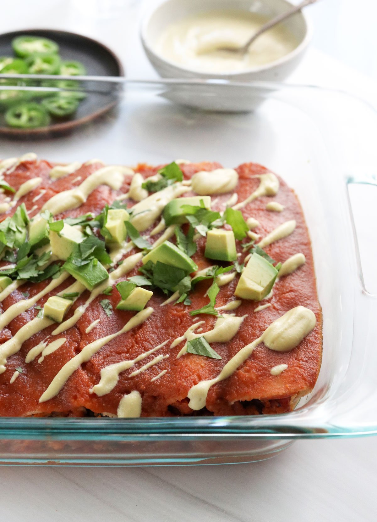 sweet potato black bean enchiladas in glass baking dish