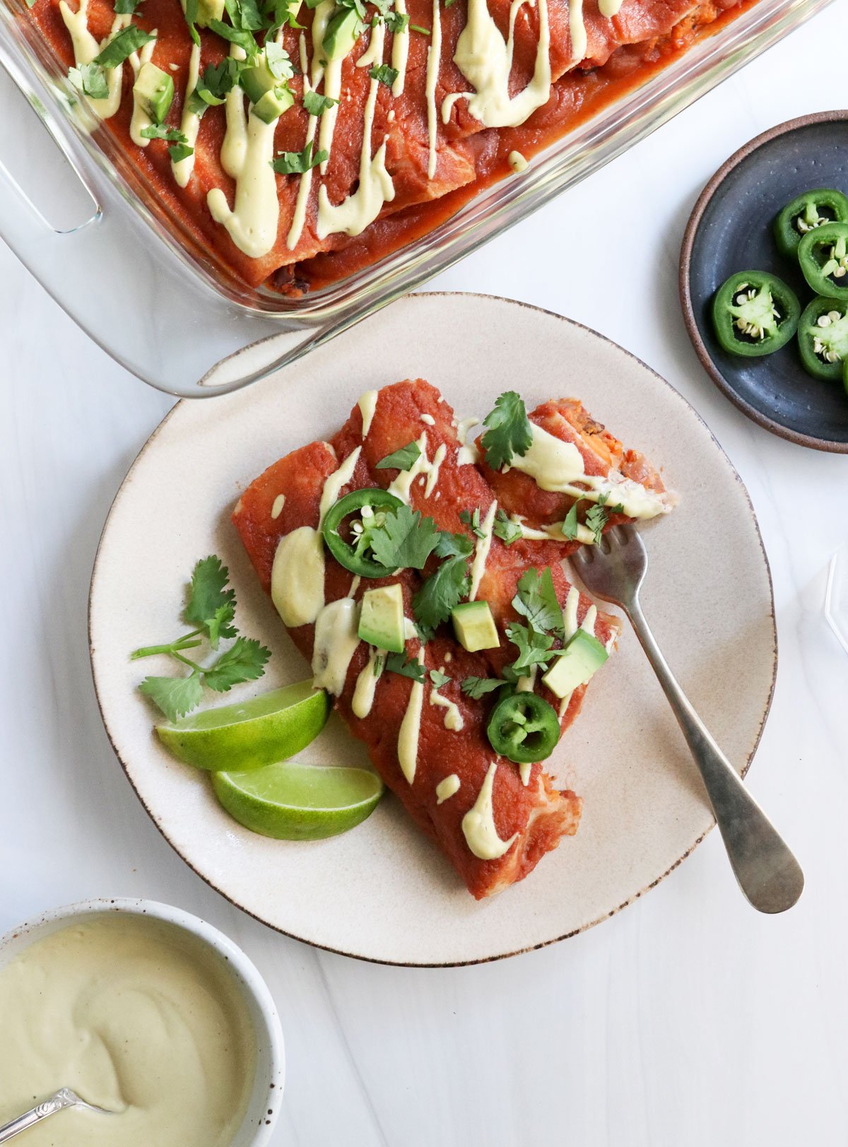 sweet potato enchiladas on plate with fork