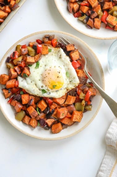 sweet potato hash on plate with egg