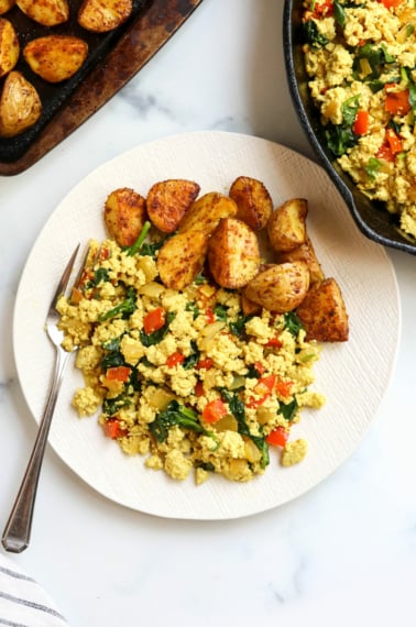 tofu scramble on plate with roasted potatoes