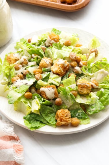 vegan caesar salad topped with croutons and chickpeas.