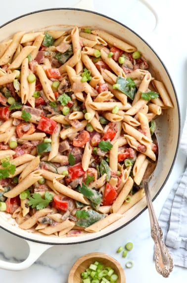 cajun pasta in white skillet with spoon