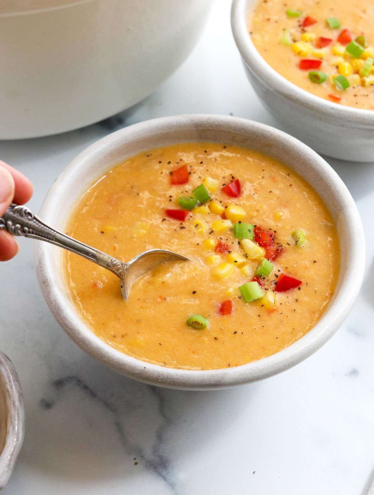 vegan corn chowder in bowl with spoon