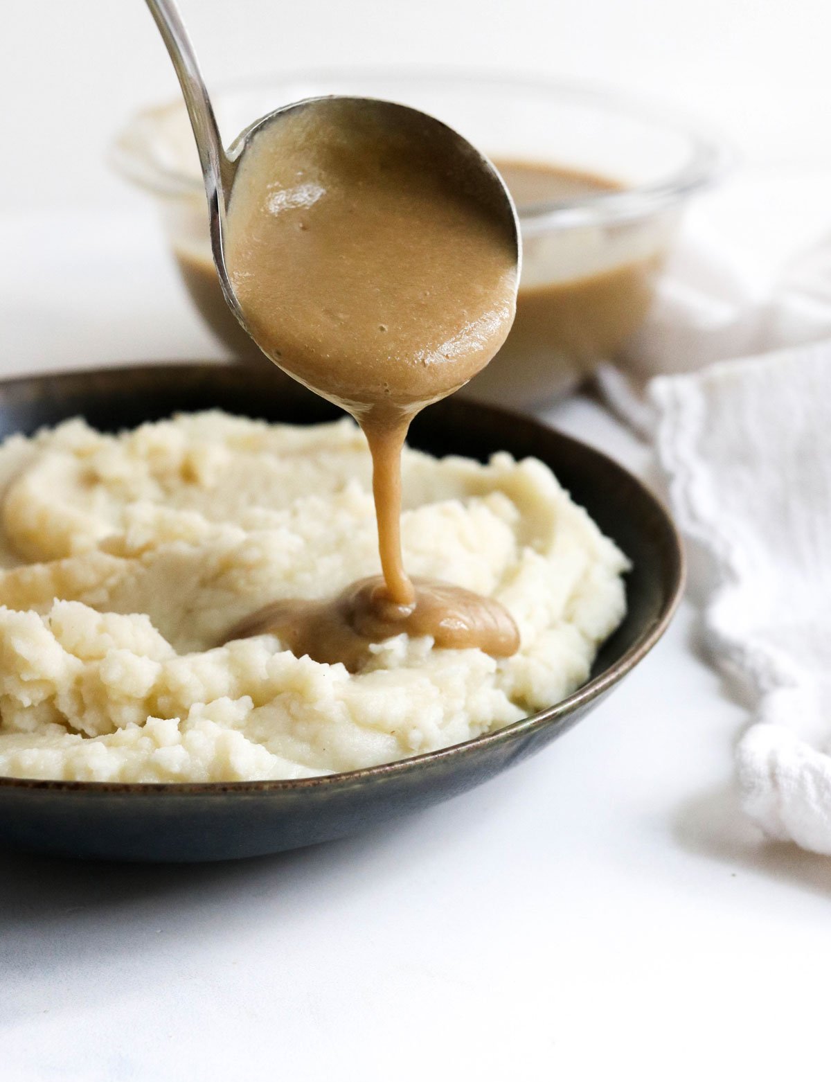 vegan gravy ladled over potatoes