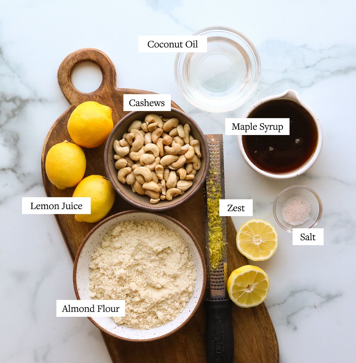 vegan lemon bar ingredients labeled on a marble surface.