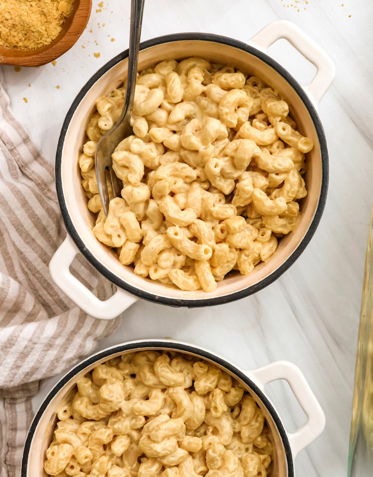 vegan mac and cheese served in small white pots.