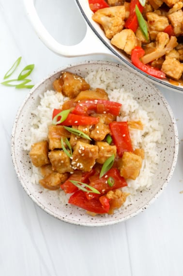 vegan orange chicken served over cooked rice.