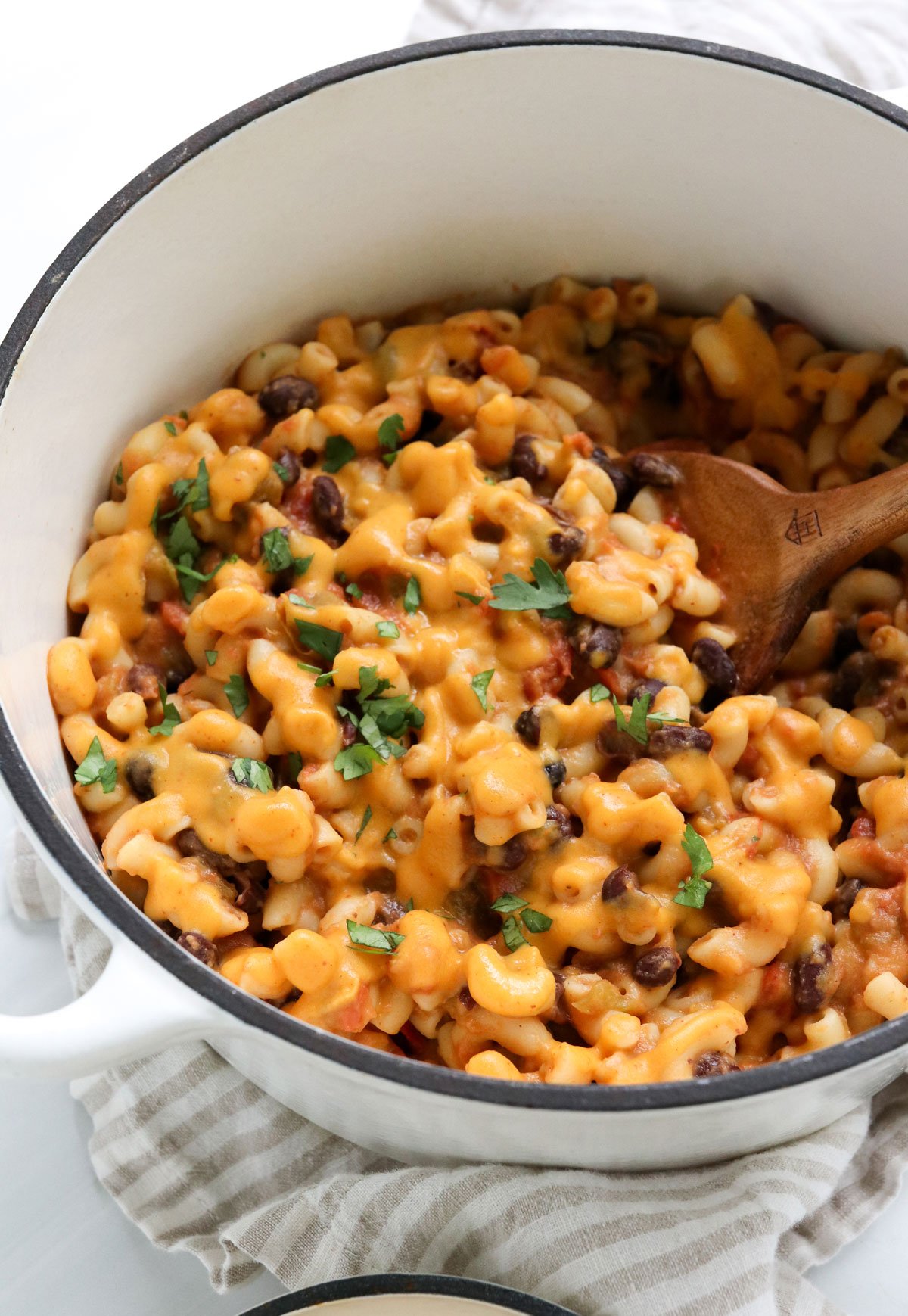 sweet potato mac & cheese topped with cilantro in white pot.