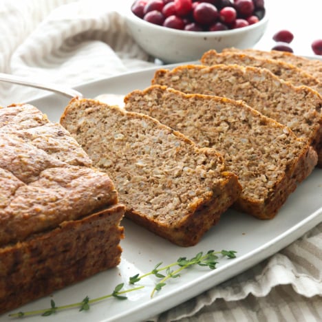 Vegetarian meatloaf sliced on a serving plate.