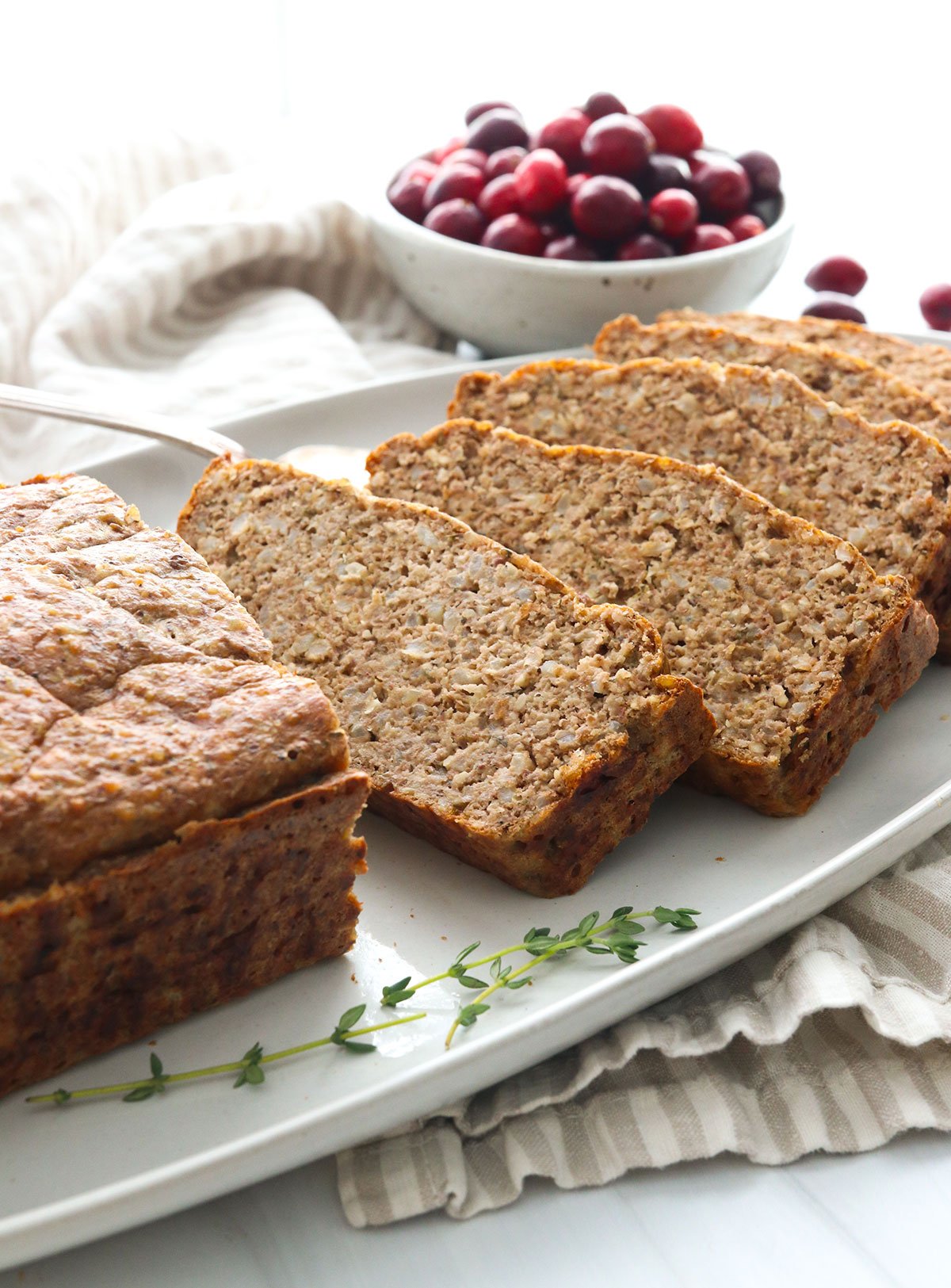 Vegetarian meatloaf sliced on a serving plate.