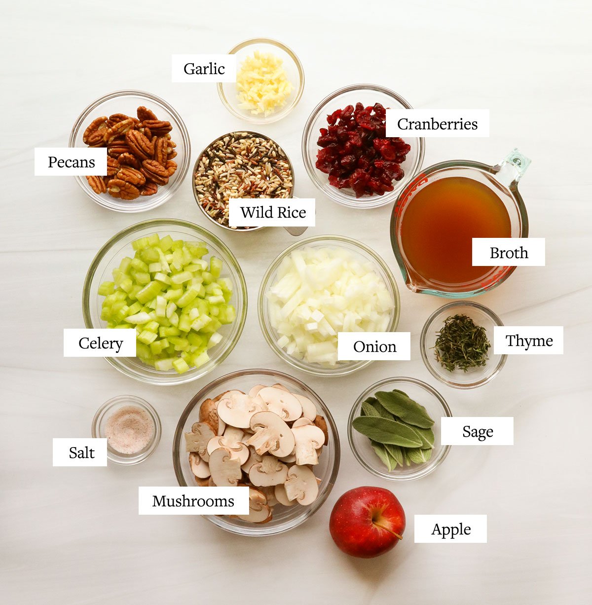 wild rice stuffing ingredients labeled in glass bowls.