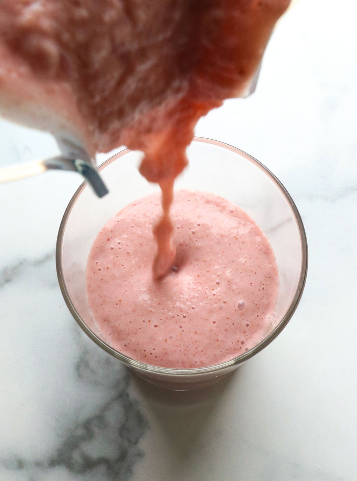 strawberry yogurt smoothie poured into a glass. 