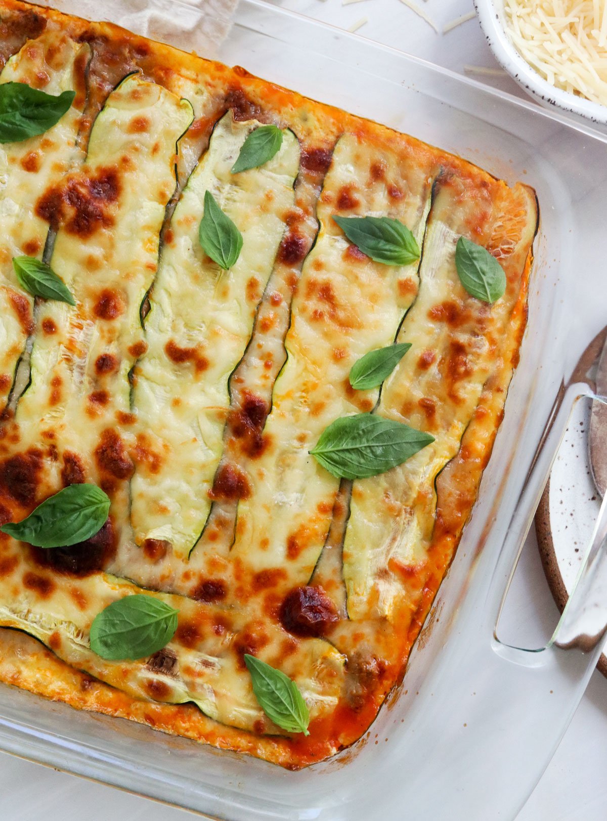 zucchini lasagna topped with fresh basil leaves.